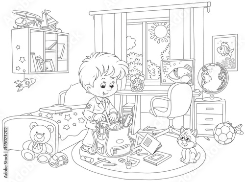 Schoolboy completing a schoolbag in his room