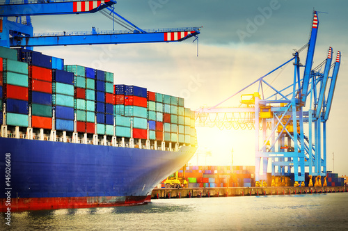 Container ship with full of cargo entering a port. Transportation background