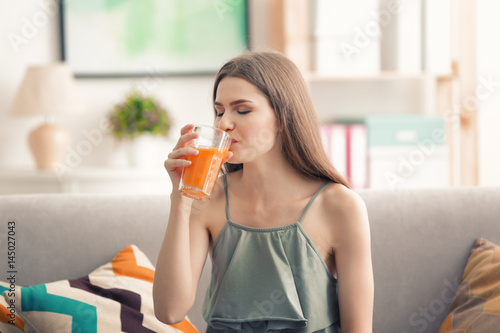 Young woman tasting fresh j...