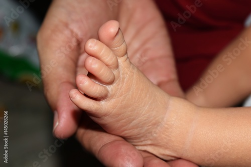 Detail feet of baby in mother hand  © Thanakon
