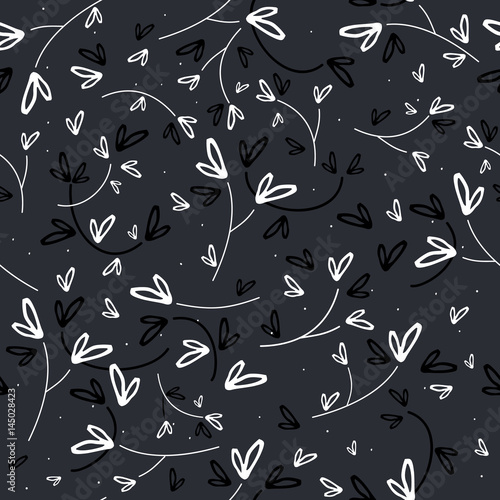 Black and white heart leaves seamless vector pattern on dark gray background.