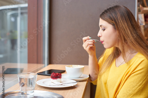 Woman eats cake.