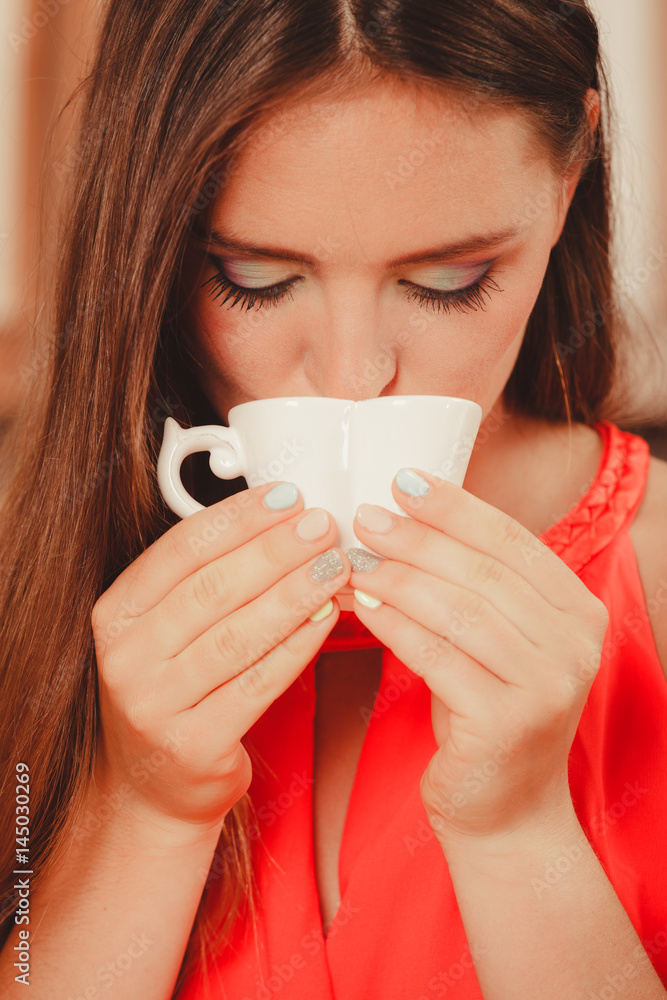 Pretty woman drinking tea or coffee at home. Pretty woman drinking tea or coffee at home.