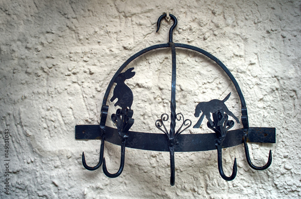 Black metal hanger. Handcrafted decorative vintage hooks in a country style home.