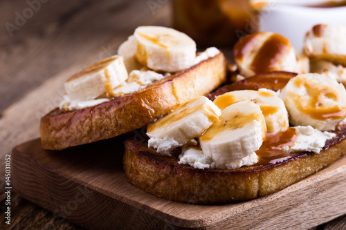 Breakfast ricotta toasts with  bananas and caramel photo