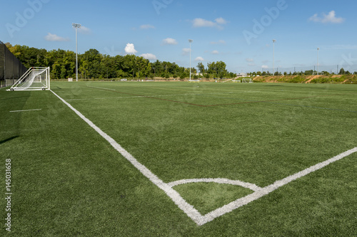 Soccer field background with a shallow depth of field on a beautiful summer day © clsdesign