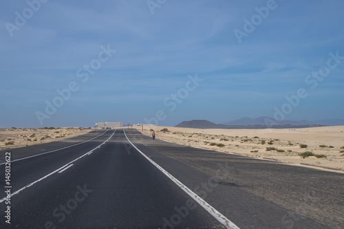 The asphalt road through the sand dunes in Canarian Island