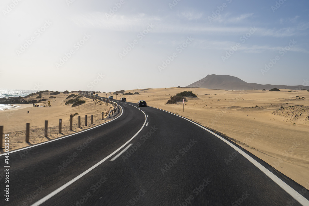 The asphalt  road through the sand dunes in Canarian Island