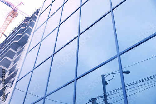 reflections of facade with blue sky and clouds