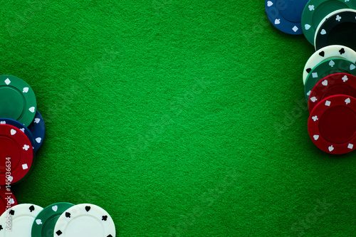 Green felt and playing chips abstract background.