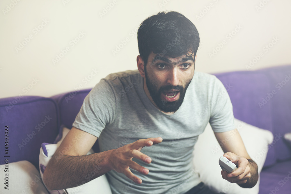 man watching tv sitting on sofa man watching tv sitting on sofa