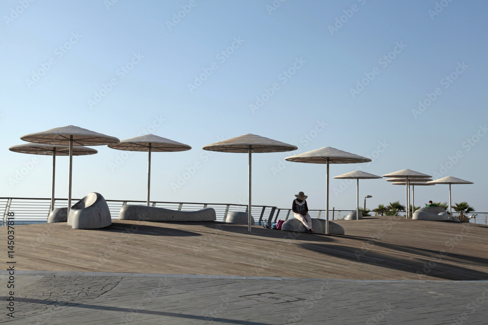 Modern beach promenade with umbrellas in Tel Aviv, Israel Modern beach promenade with umbrellas in Tel Aviv, Israel