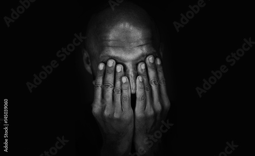 Sad man covered his face with his hands