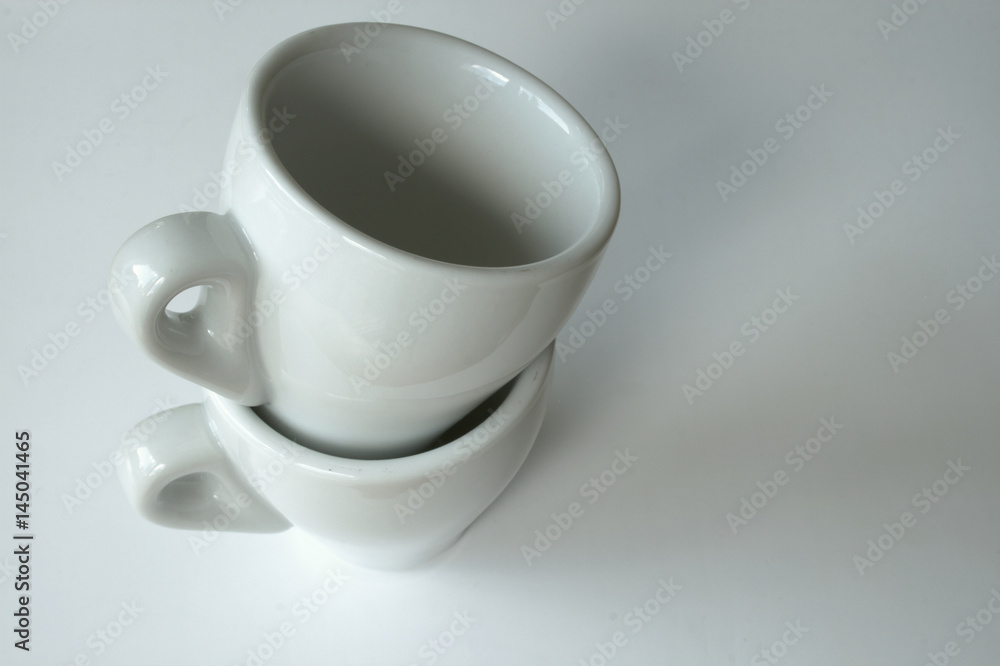 Stack of two empty espresso cups isolated on white background Stack of two empty espresso cups isolated on white background