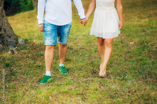 Female and male feet on grass. Wedding in Montenegro