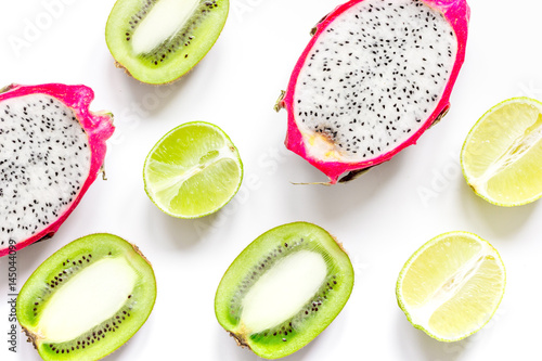 Tropical fruit design on white table background top view