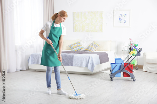 Woman with mop cleaning home