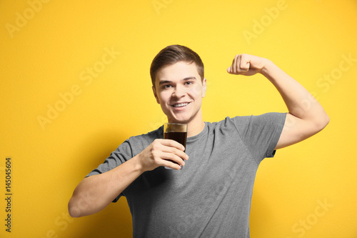 Young man drinking juice on...