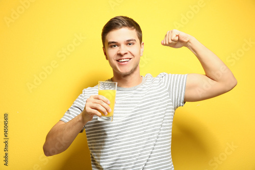 Young man drinking juice on...