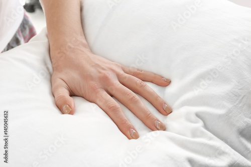 Female hand on orthopedic pillow  closeup