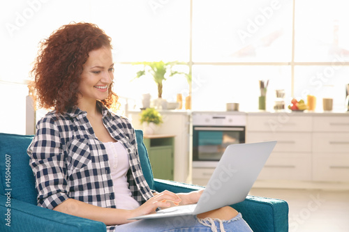 Beautiful young woman using...