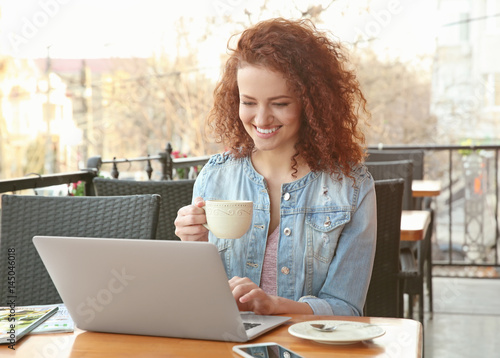 Beautiful young woman using...