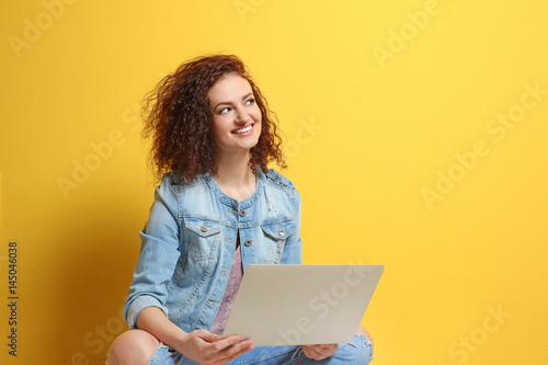 Beautiful young woman using...