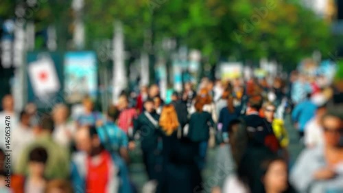 Wallpaper Mural Crowd of People / Commuters Walking / Busy Street. Anonymous crowd on a busy street. People walk down a busy street with green trees on a hot summer day. Slow motion. Torontodigital.ca
