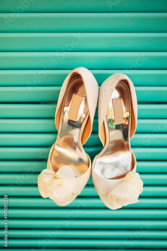 Wedding shoes of the bride on a blue wooden background. Wedding in Montenegro.