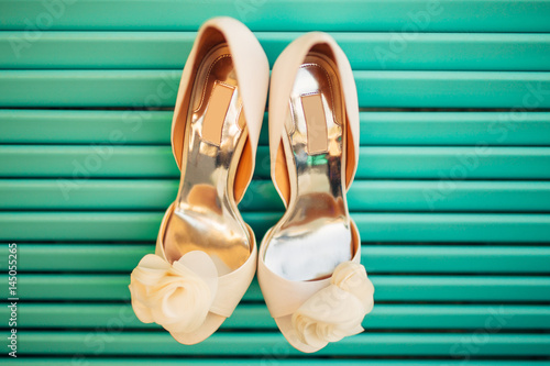 Wedding shoes of the bride on a blue wooden background. Wedding in Montenegro.