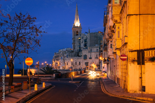 Valletta seafront at night with St. Paul's Anglican Cathedral, Malta