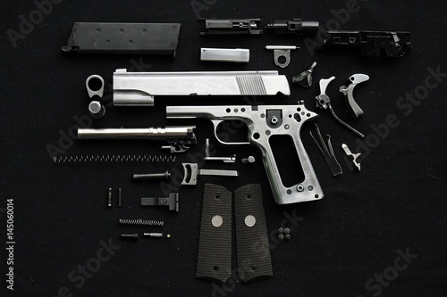 Canvas-taulu Disassembled handgun on black background,