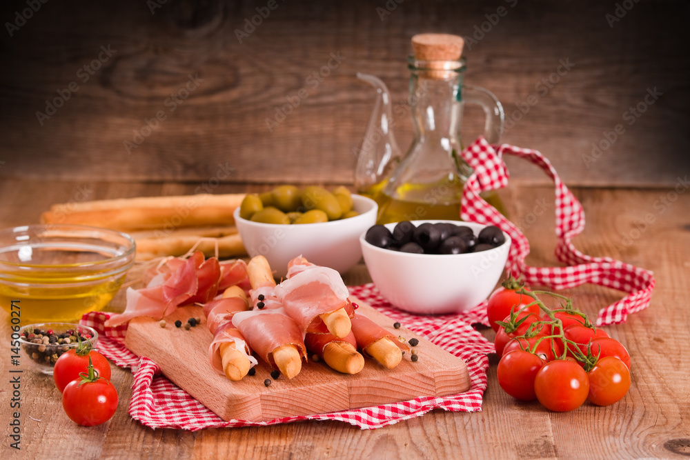 Grissini breadsticks with ham. Grissini breadsticks with ham.