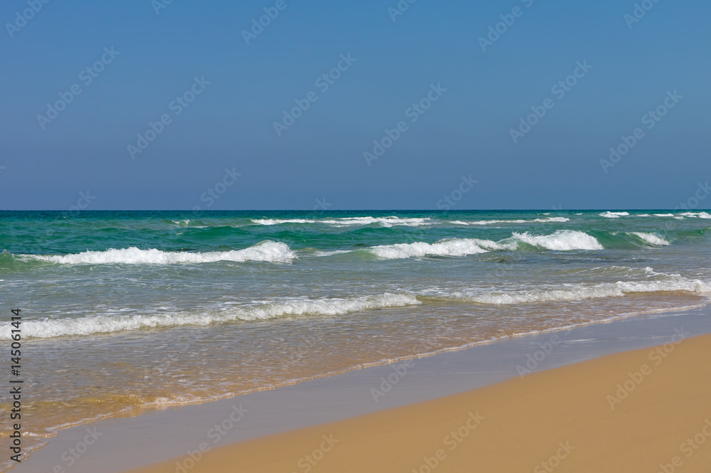 Peaceful ocean wave at beach. Smooth sand.