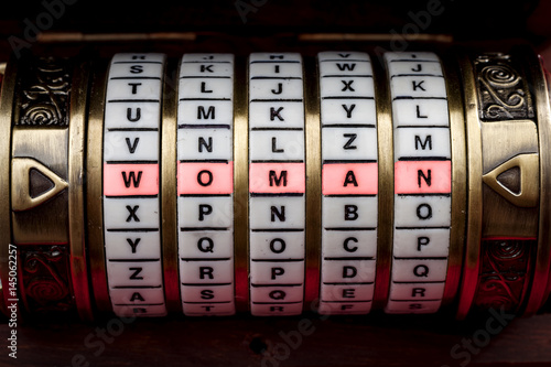 Fotografie Women are a mystery or a woman is complicated to understand concept with the word woman spelled on a puzzle box or Cryptex