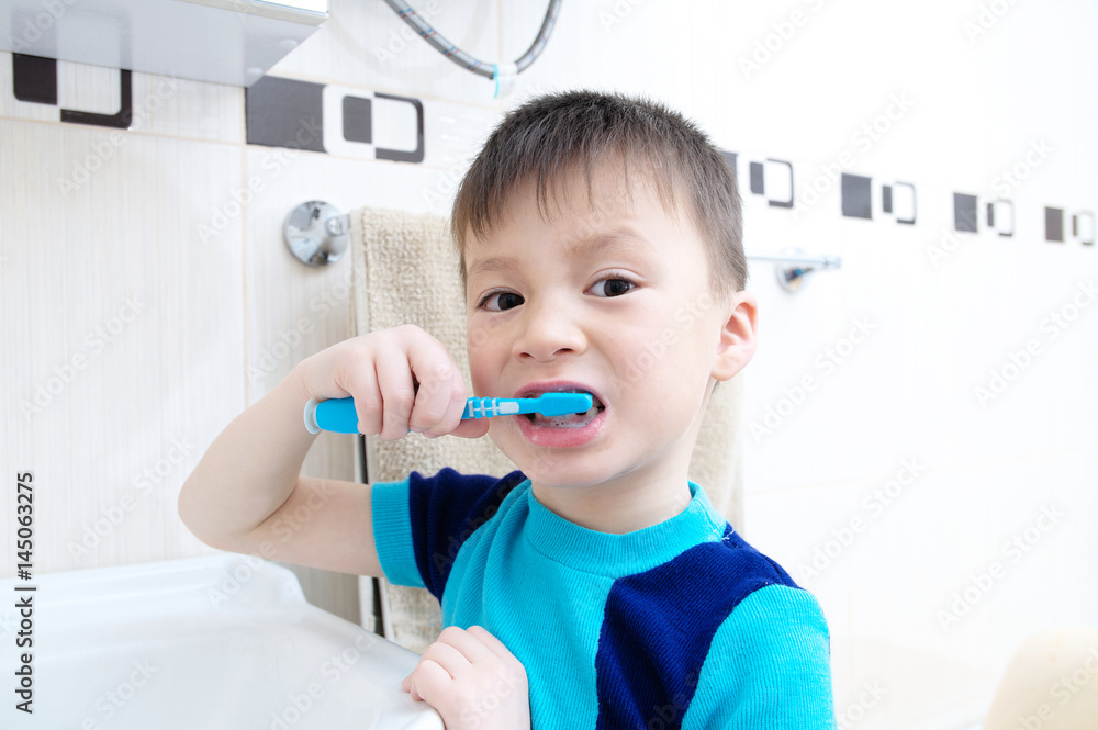 Boy brushing teeth, child dental care, oral hygiene concept, child in bathroom with tooth brush,healthy lifestyle Boy brushing teeth, child dental care, oral hygiene concept, child in bathroom with tooth brush,healthy lifestyle
