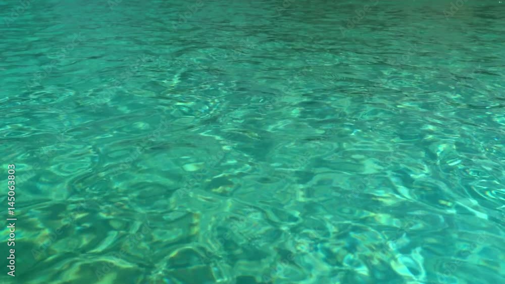 Water in the pool, sunlight is reflected, small waves, Shot from a tripod 4k video Water in the pool, sunlight is reflected, small waves, Shot from a tripod 4k video