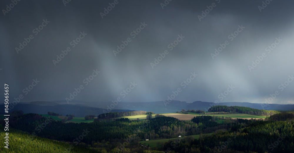 dark rainy clouds and shafts of sunlight dark rainy clouds and shafts of sunlight