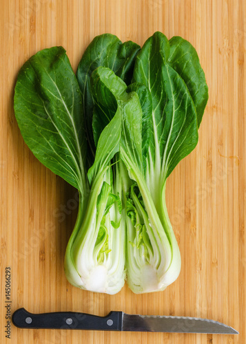 Bok choy with  knife on wooden background. Pak choy is a type of Chinese cabbage(Qing geng cai )and one of the healthiest vegetable and popular superfood.