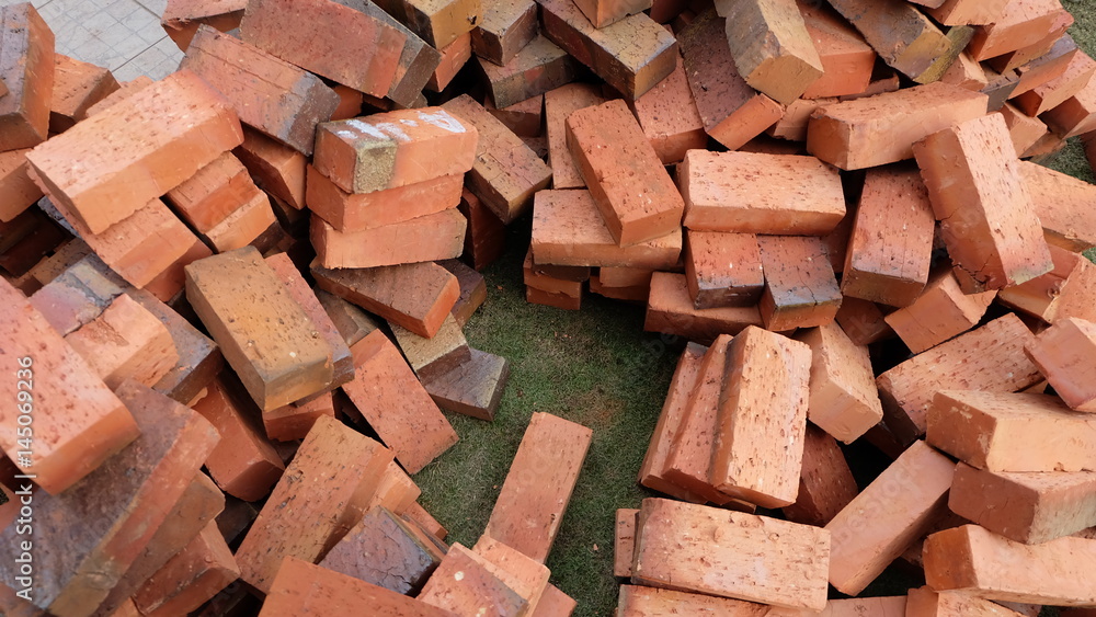 Piles of bricks on top of lawn