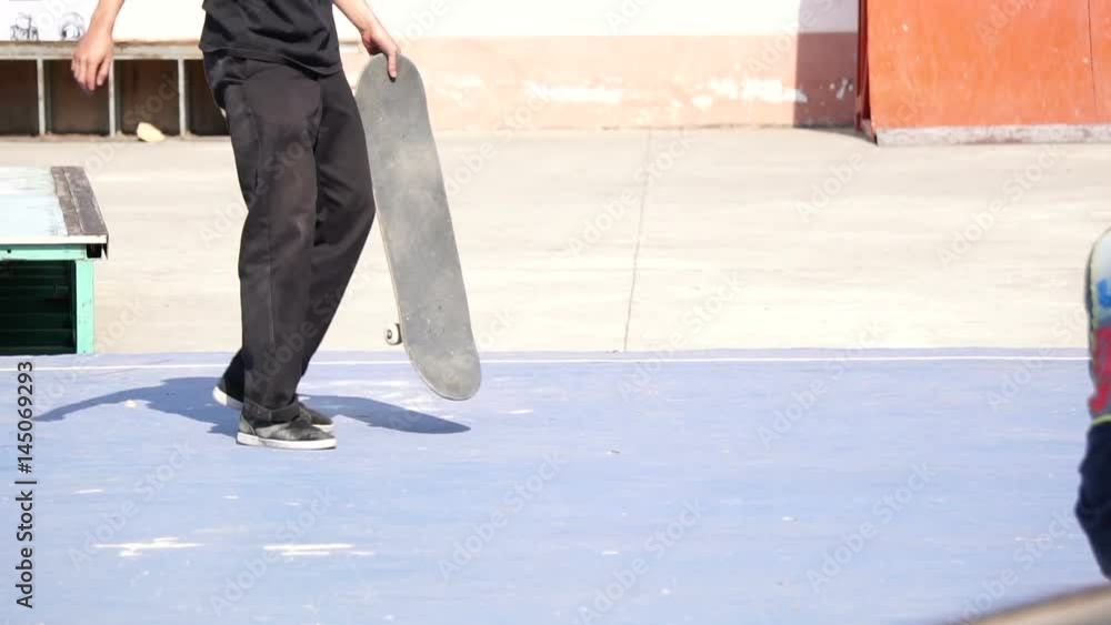 A man playing skateboard trick on concrete floor in slow motion A man playing skateboard trick on concrete floor in slow motion