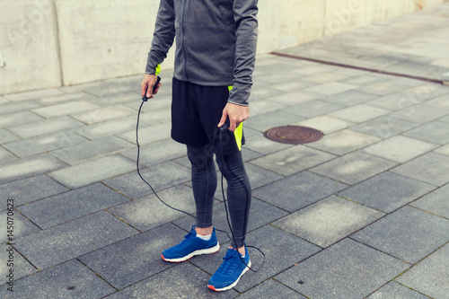 close up of man exercising with jump-rope outdoors