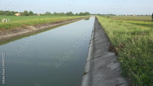 Wallpaper Mural water of irrigation channel flowing through concrete walls along cultivated fields Torontodigital.ca