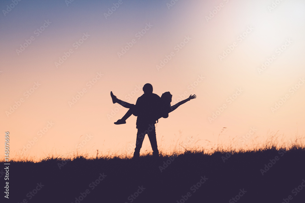 Silhouette Of People having fun at sunset time