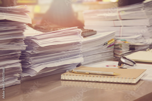 Business Concept, Pile of unfinished documents on office desk, Stack of business paper, Vintage Effect photo