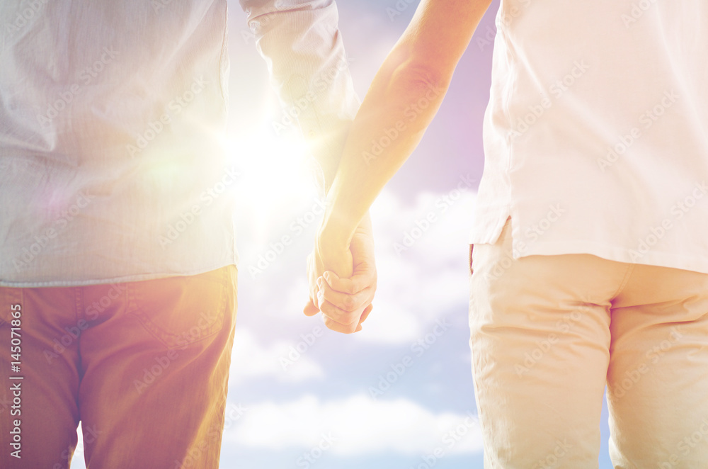 close up of happy male gay couple holding hands close up of happy male gay couple holding hands