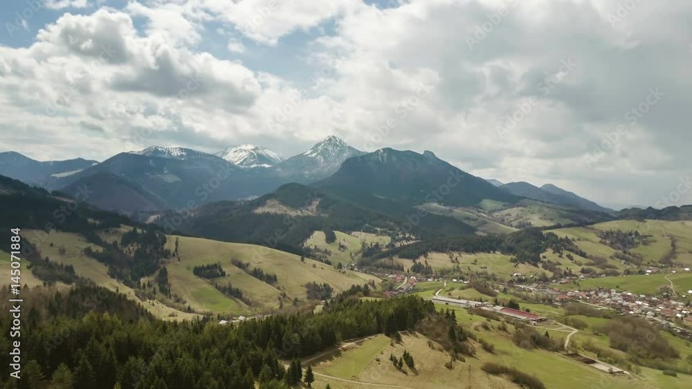 Aerial flight over spring landscape with clouds moving over mountains time lapse. Pan left to right Aerial flight over spring landscape with clouds moving over mountains time lapse. Pan left to right