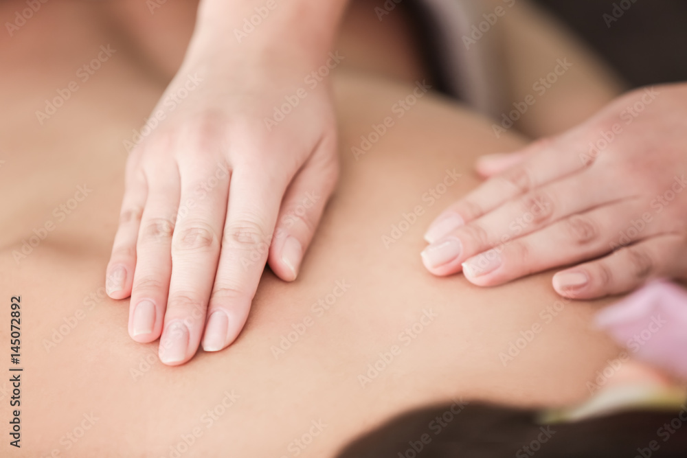 Young woman having massage in spa salon Young woman having massage in spa salon