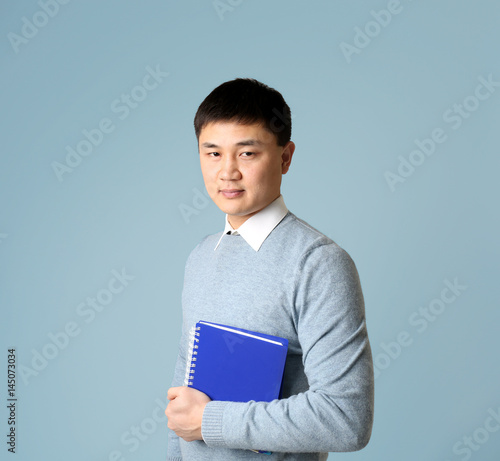 Handsome young Asian teache...