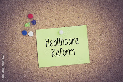 Healthcare Reform written on sticky note pinned on pinboard photo